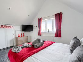 A bedroom with a bed and television at Ruby Red Near Brigg