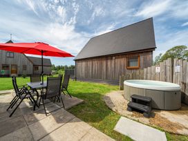An outdoor area with a table and chairs under an umbrella at Ruby Red near Brigg