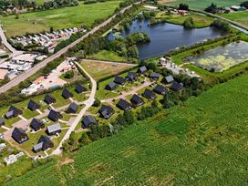 An aerial view of houses and a pond at Ruby Red near Brigg