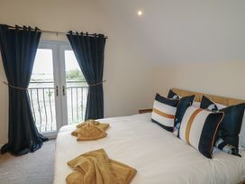 A bedroom with a bed and pillows at Poker Lodge in Brigg