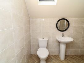 A bathroom with a toilet and sink at Poker Lodge in Brigg