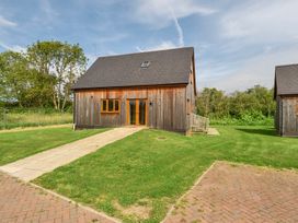 A house with a pathway and grass at Poker Lodge Near Brigg