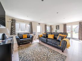 A living room with a sofa and television at Poker Lodge Near Brigg