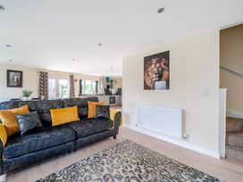 A living room with a sofa and rug at Poker Lodge near Brigg