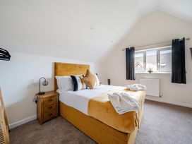 A bedroom with a bed and window at Poker Lodge near Brigg