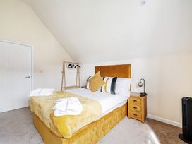 A bedroom with a bed and bedside table at Poker Lodge Near Brigg