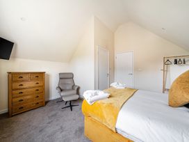 A bedroom with a bed and dresser at Poker Lodge near Brigg