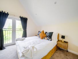A bedroom with a bed and nightstand at Poker Lodge Near Brigg