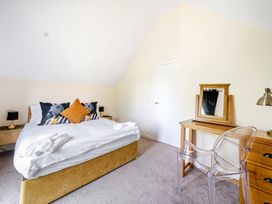 A bedroom with a bed and a mirror at Poker Lodge Near Brigg