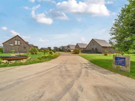An outdoor area with lodges and pathway at Poker Lodge Near Brigg