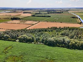 An aerial view of fields and forests at Poker Lodge Near Brigg