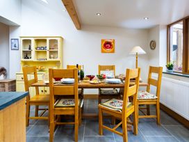 A dining room with a table set for a meal at Oakdene in Keswick