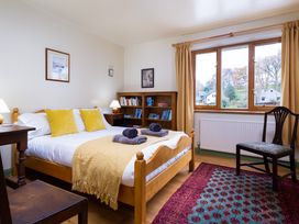 A bedroom with a bed and bookshelf at Oakdene in Keswick