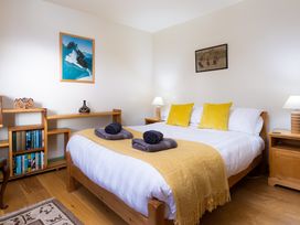 A bedroom with bed and bookshelf at Oakdene in Keswick