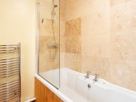A bathroom with a bathtub and shower at Oakdene in Keswick