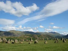 A landscape with standing stones and mountains at Oakdene in Keswick
