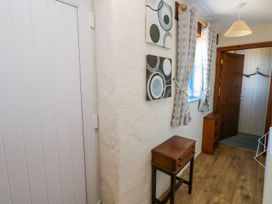 A hallway with a table and wall art at Casa Mia Goodwick