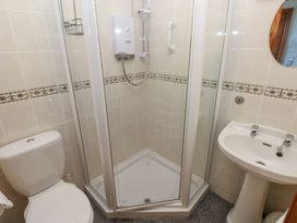 A bathroom with a shower, toilet, and sink at Casa Mia in Goodwick