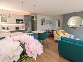 An open plan living area with kitchen and dining furniture at Galvayne in Dartmouth