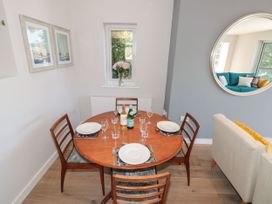 A dining room with a table set for a meal at Galvayne in Dartmouth