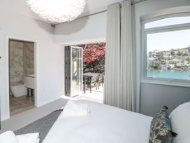 A bedroom with an ensuite bathroom and access to an outdoor area at Galvayne in Dartmouth