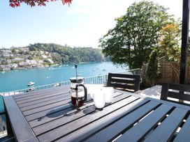 A table with a french press and cups overlooking a water view at Galvayne in Dartmouth