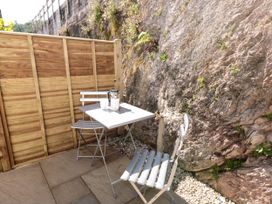 An outdoor seating area with a table and chairs at Galvayne Dartmouth