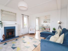 A living room with a fireplace and seating area at Ms Merryn 37 St. Cadocs