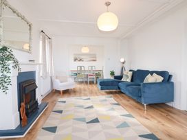 A living room with a sofa and fireplace at Ms Merryn 37 St. Cadocs