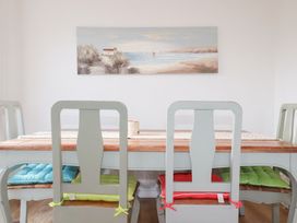 A dining room with a table and chairs at Ms Merryn 37 St. Cadocs