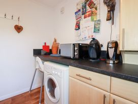A kitchen with appliances and wall decor at Ms Merryn 37 St. Cadocs