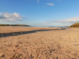 A beach with sand and ocean waves at Ms Merryn 37 St. Cadocs Tregolds near St Merryn