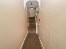 A staircase and door in a hallway at The English School, Flat 2 Dartmouth