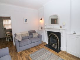 A living room with a sofa and fireplace at The English School, Flat 2 in Dartmouth