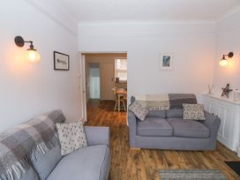 A living room with a sofa and light fixtures at The English School, Flat 2 in Dartmouth