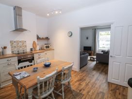 A kitchen with a dining table and living area at The English School, Flat 2 Dartmoor