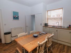 A kitchen with a table and chairs at The English School, Flat 2 Dartmouth