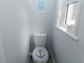 A bathroom with a toilet and a framed picture at The English School, Flat 2 in Dartmouth