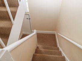 A staircase with carpet and handrail at The English School, Flat 2 in Dartmouth