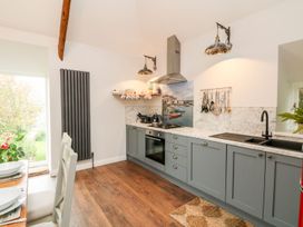 A kitchen with cabinets and appliances at The Old Byre in Falmouth