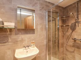 A bathroom with a shower and sink at The Old Byre in Falmouth