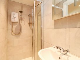 A bathroom with a shower and sink at The Old Byre in Falmouth