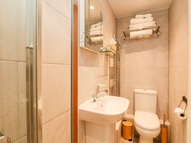A bathroom with shower, toilet, and sink at The Old Byre in Falmouth
