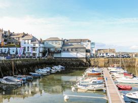 A harbor with boats and buildings at The Old Byre in Falmouth