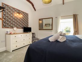 A bedroom with a bed and a dresser at The Forge in Falmouth