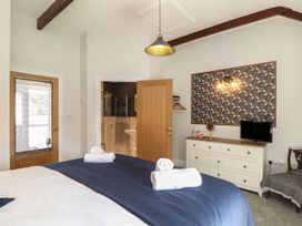 A bedroom with a bed and television at The Forge in Falmouth