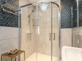 A bathroom with a shower and bathtub at The Forge in Falmouth