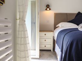A bedroom with a bed and bedside table at The Forge in Falmouth