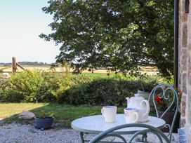An outdoor seating area with a table and chairs at The Forge in Falmouth
