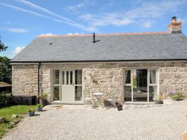A house with a door and windows surrounded by gravel at The Forge in Falmouth